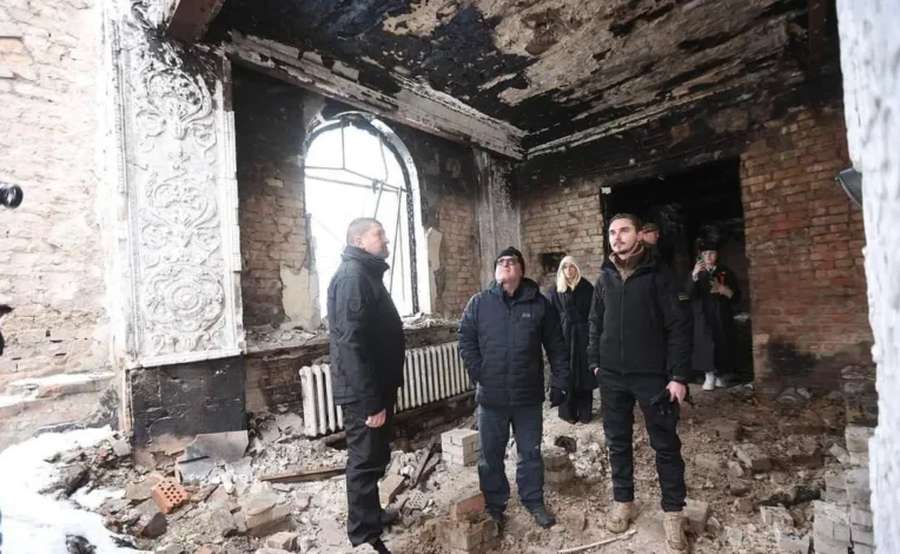 Joseph Kelly in one of the destroyed buildings in Irpin